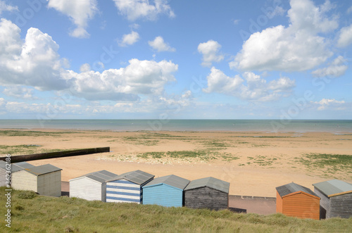 Beach and beach huts at Minnis Bay, Kent, UK in the Summer