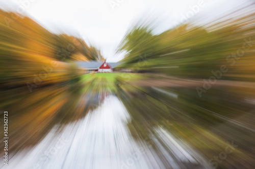 The house is surrounded by an autumn forest, standing on the shore of a lake. photographed with different effects of motion and zoom.