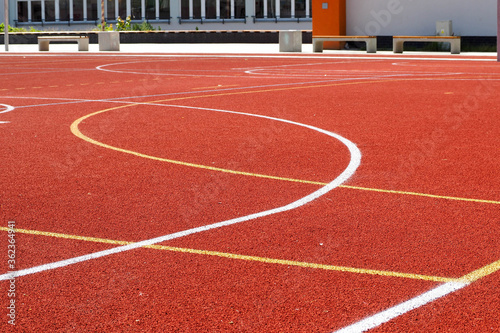 Red soccer field with white and orange stripes . stadium
