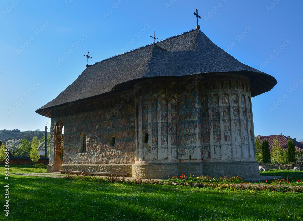 HUMORULUI MONASTERY, BUCOVINA, ROMANIA, EUROPE, SPRING 2018. Orthodox monastery. Moldovan architectural style. Outdoor paintings, frescoes and portraits of saints with Byzantine influence.