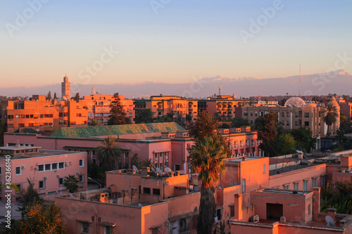 Top view of Marrakech at sunset. The Atlas mountains are visible in the distance. Marrakech, Morocco