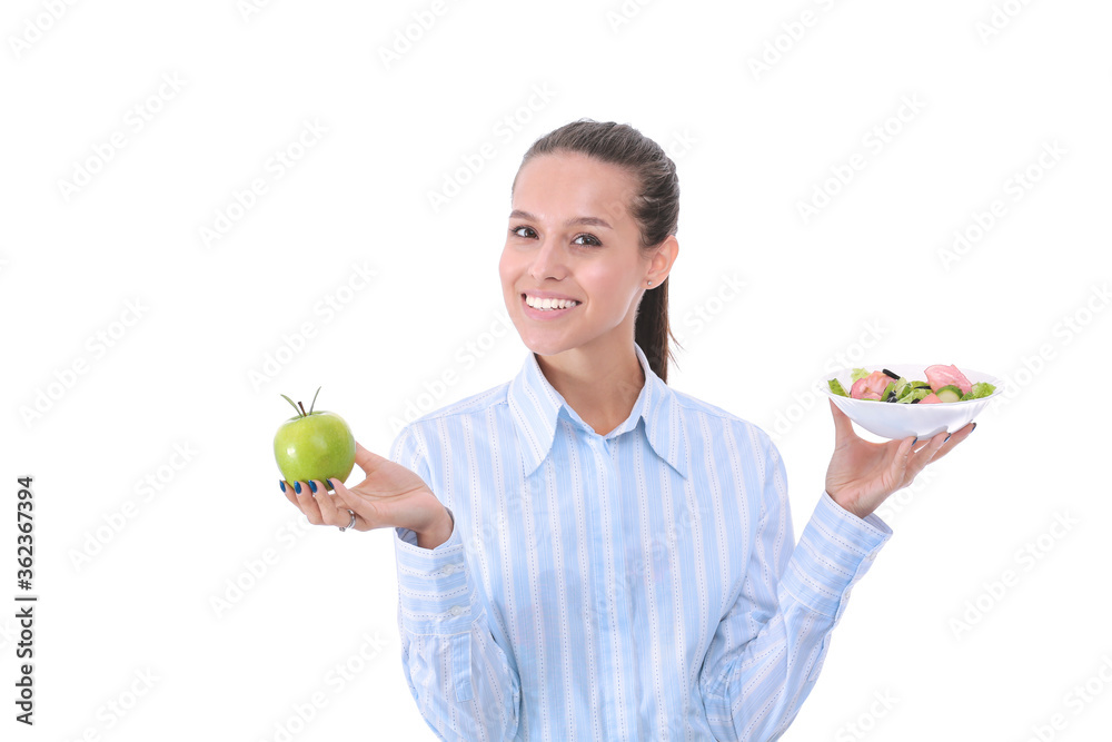 Portrait of a beautiful woman doctor holding a plate with fresh vegetables and green apple. Woman doctor Portrait of a beautiful woman doctor holding a plate with fresh vegetables and green apple. Woman doctor