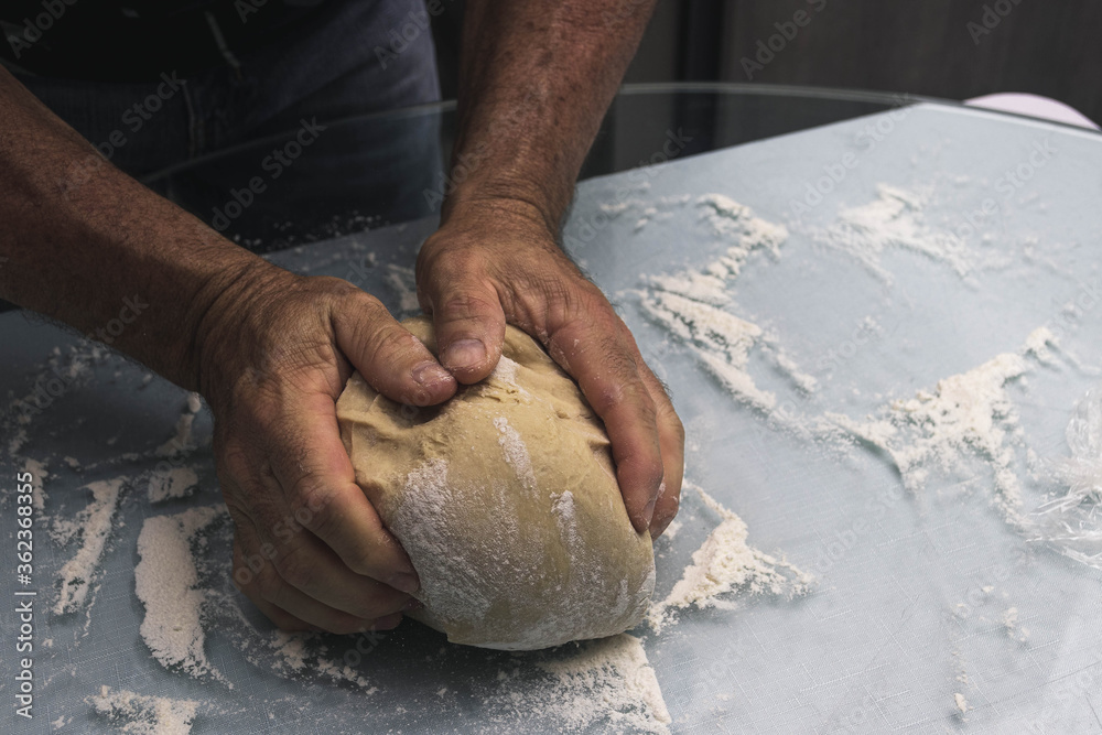 Hands doing the process of kneading raisin bread