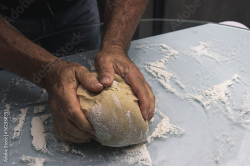Fototapeta Naklejka Na Ścianę i Meble -  Hands doing the process of kneading raisin bread