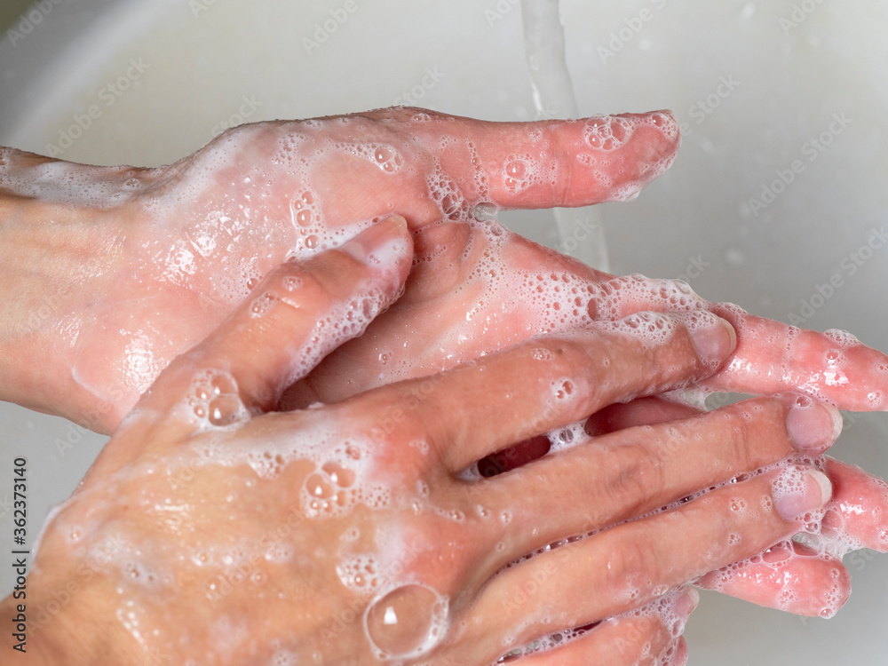 hand washing with soap. Concept of personal hygiene, countering viruses and microbes