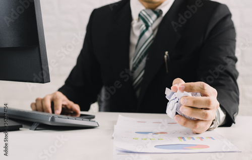 businessman emotions and fail concept crumpled paper on table with, unhappy no idea to thinking throwing papers in office