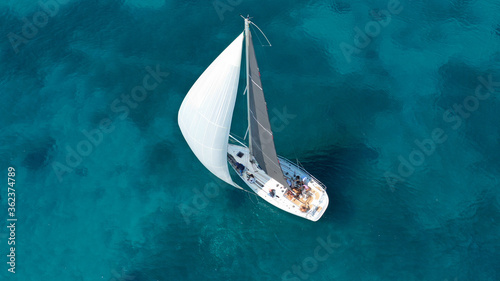 Aerial drone photo of beautiful sail boat cruising in low speed the Ionian turquoise calm sea