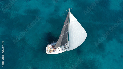 Aerial drone photo of beautiful sail boat cruising in low speed the Ionian turquoise calm sea © aerial-drone