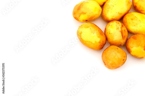 Raw potatoes on white background. Fresh potatoes on isolated. Early harvest. Washed vegetables. Selective focus. Concept of culinary skill. Place for an inscription or logo
