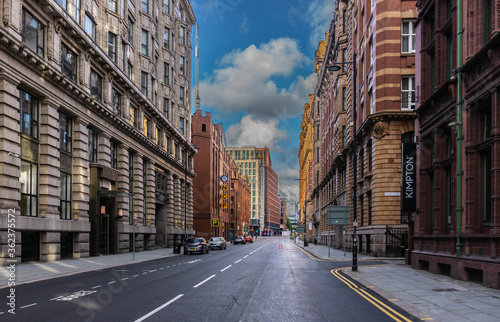 Print op canvas An empty streetscene of Whitworth Street under a vibrant blue sky