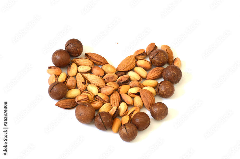 Set of nuts in a shape of heart on white background,photo ,snack Set of nuts in a shape of heart on white background,photo ,snack