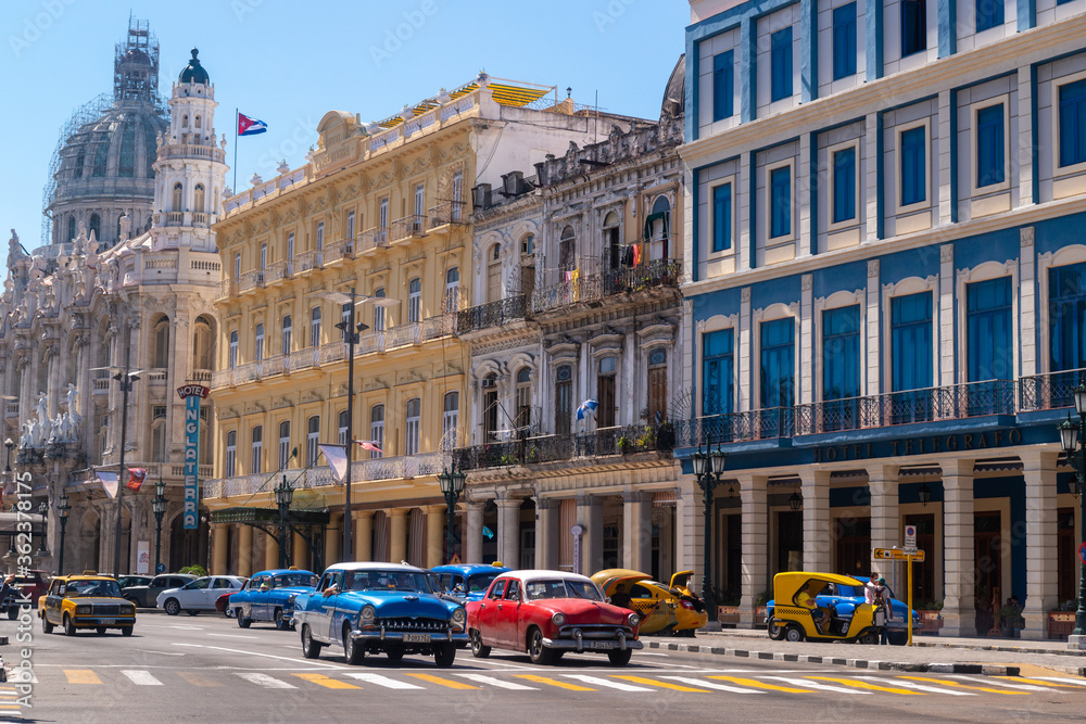 Havana, Cuba in February 2018. Traditional and colorful old cars with old buildings in the background.