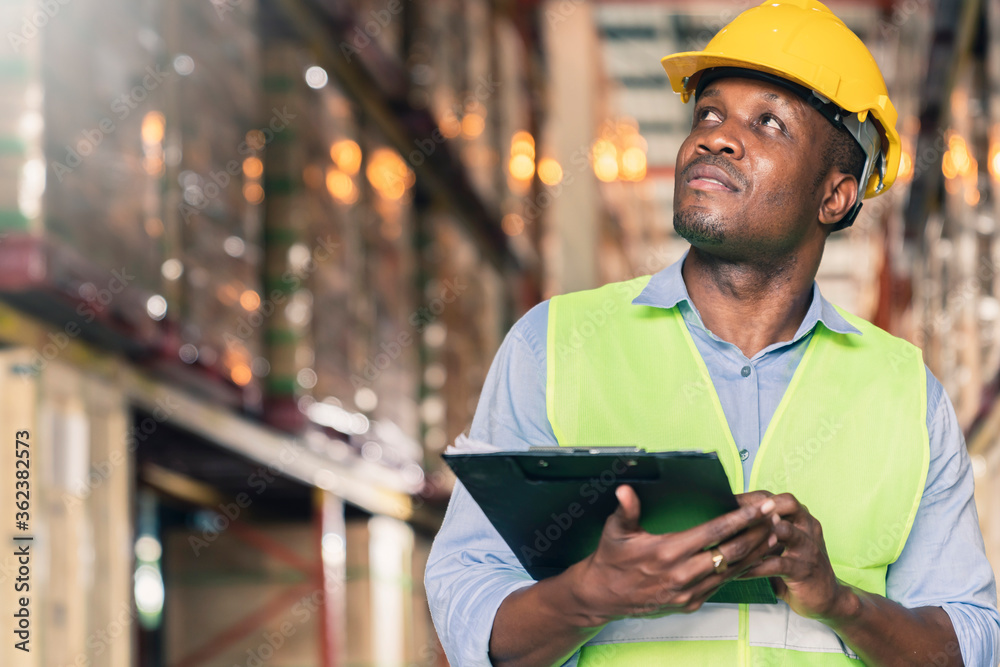 portrait of smart caucasian male engineer inspector hand hold paper chart inventory checking smile confident with background of ware house and wooden pallet of product stock portrait of smart caucasian male engineer inspector hand hold paper chart inventory checking smile confident with background of ware house and wooden pallet of product stock