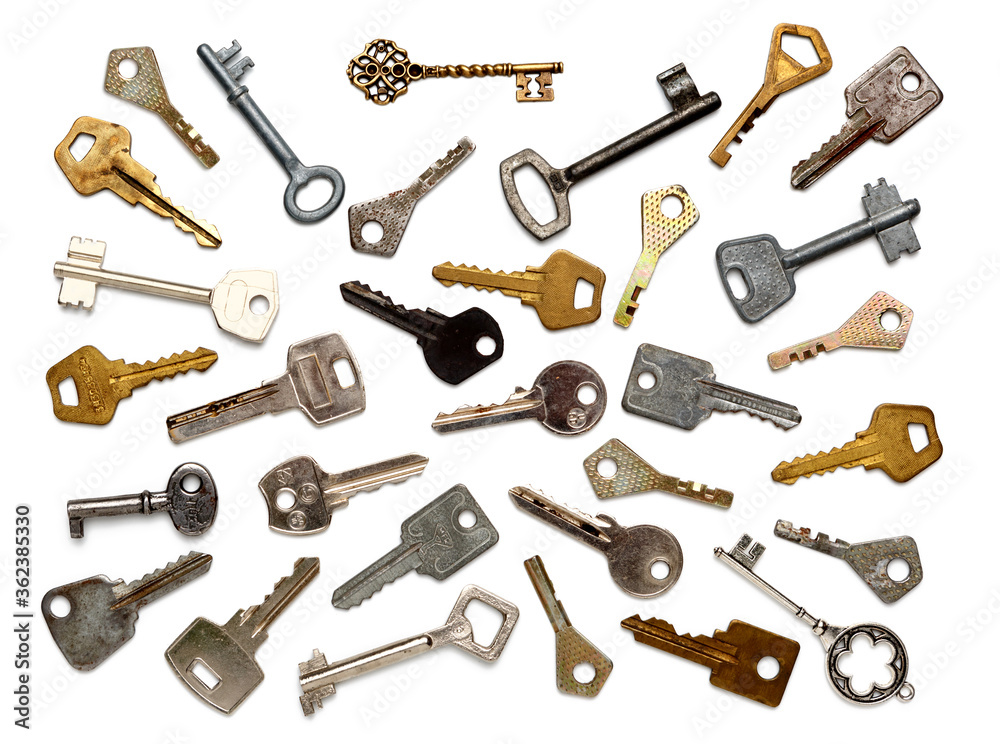Old keys of different shapes isolated on white background. Flat lay, top view. Old keys of different shapes isolated on white background. Flat lay, top view.