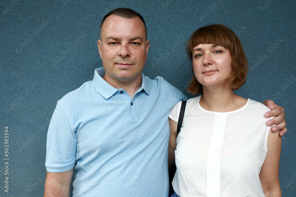 Couple on blue cement wall background Couple on blue cement wall background