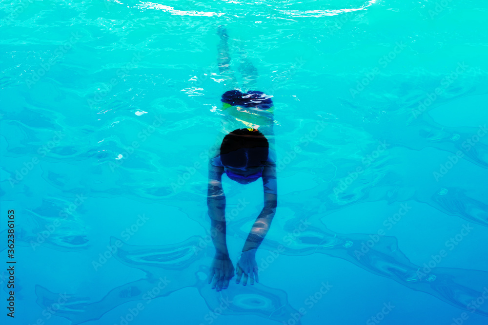 Athlete swimmer swims underwater, top view. Healthy lifestyle and sport concept.