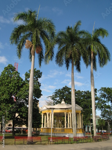 Main square with yellow bandstand and three palm trees, Santa Clara, Cuba