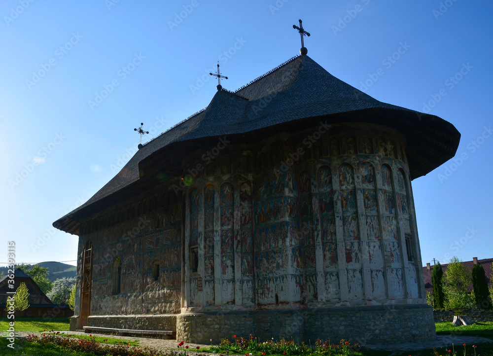 HUMORULUI MONASTERY, BUCOVINA, ROMANIA, EUROPE, SPRING 2018. Orthodox monastery. Moldovan architectural style. Outdoor paintings, frescoes and portraits of saints with Byzantine influence.