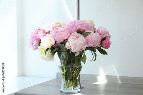 Fototapeta Naklejka Na Ścianę i Meble -  Bouquet of beautiful peonies in vase on wooden table