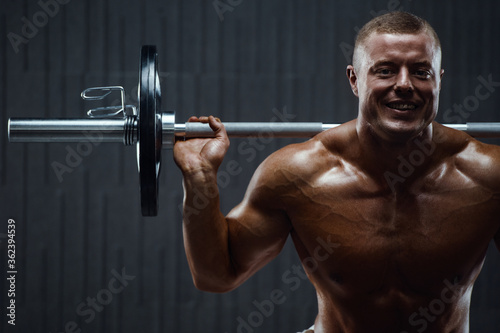 Caucasian man pumping up muscles. fitness training
