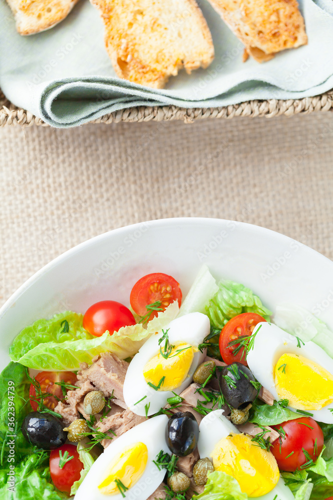 Chef's salad with tuna fish, black olives and egg in caper-mayonaisse sauce.