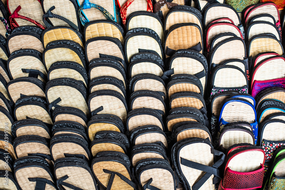 rows of sandals in a market stall