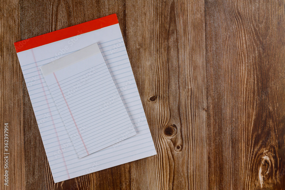 Topview of blank various note paper page on wood background office desk Topview of blank various note paper page on wood background office desk