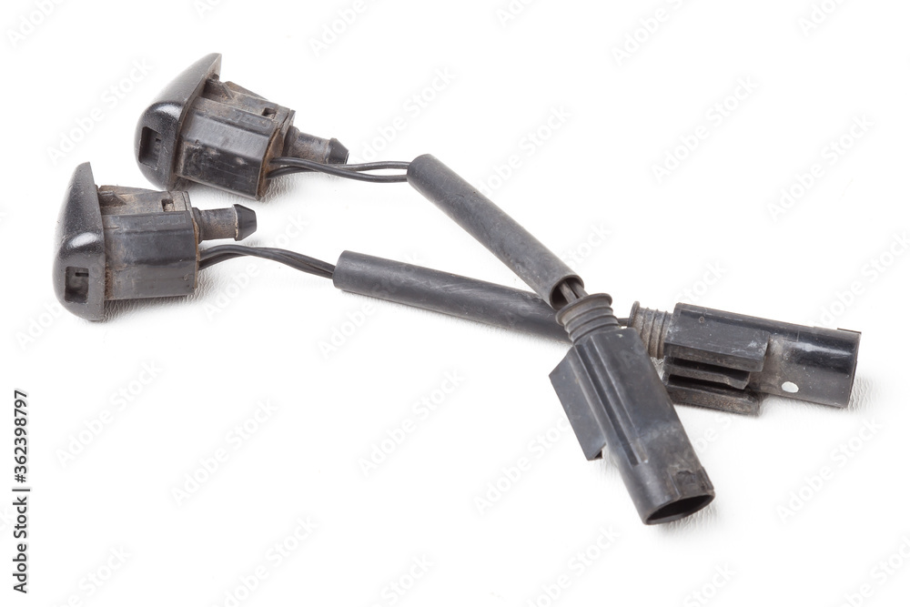 Sale of spare parts during auto-analysis or car repair after an accident and breakdown in service on a white isolated background in a photo studio - a pair of windshield washer nozzles.