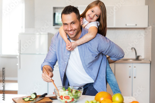 Happy Father And Daughter Cooking Together Posing In Kitchen Indoors