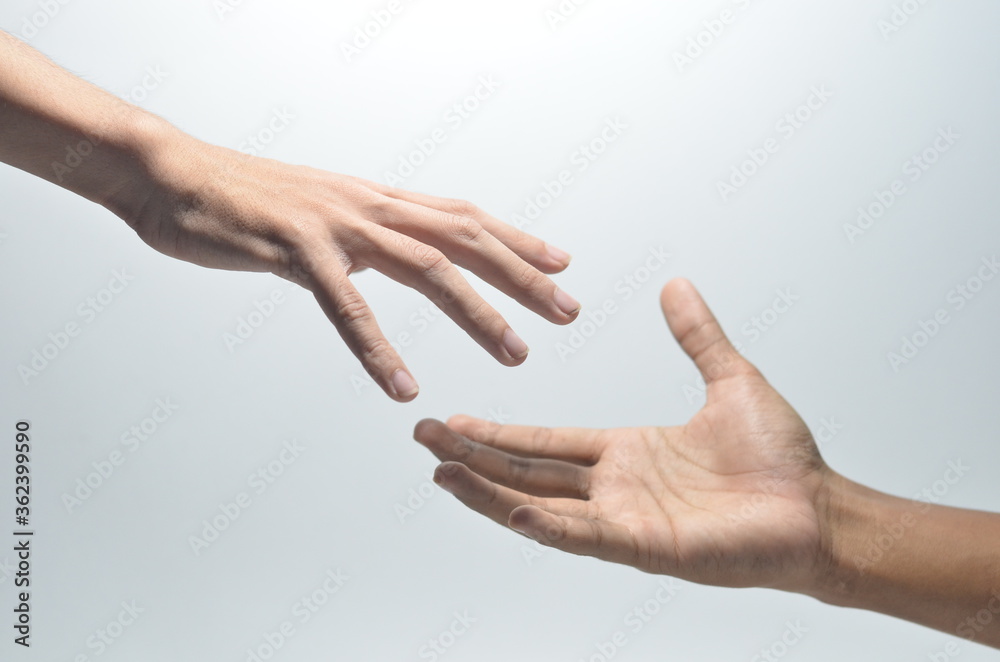 Two male hands reaching towards each other on isolated white background Two male hands reaching towards each other on isolated white background