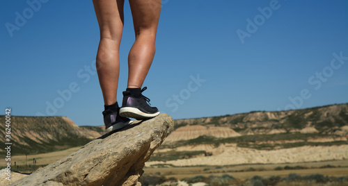 legs of a young woman in the top of a desert mountain