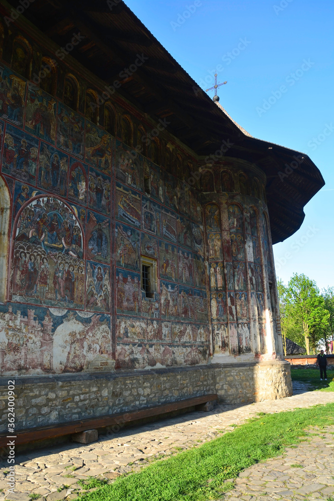 HUMORULUI MONASTERY, BUCOVINA, ROMANIA, EUROPE, SPRING 2018. Orthodox monastery. Moldovan architectural style. Outdoor paintings, frescoes and portraits of saints with Byzantine influence.