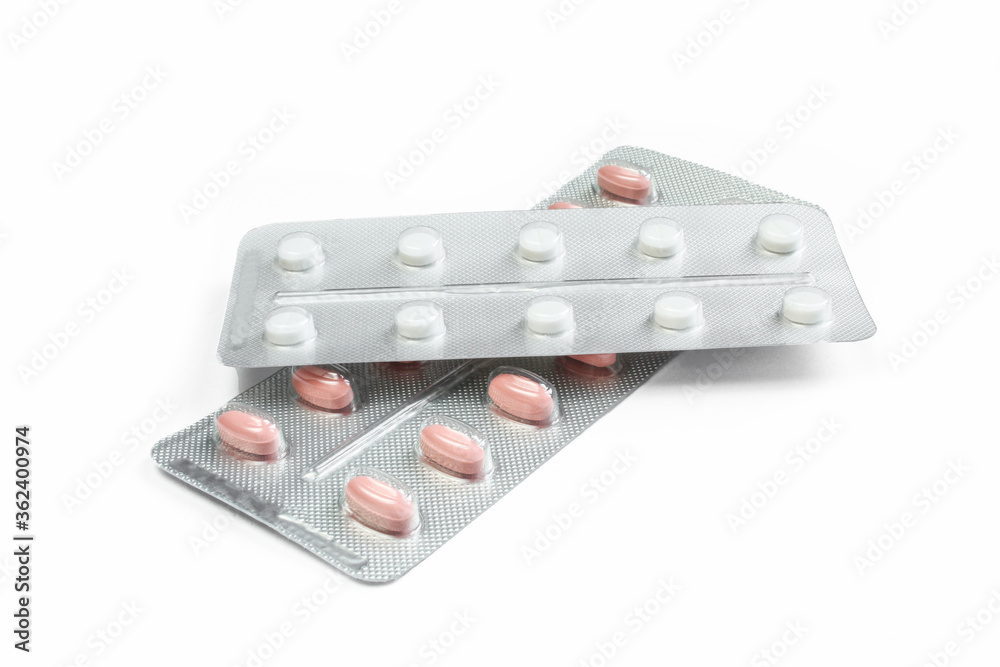 White and red pills in packs isolated on white background. Medications in blister packaging White and red pills in packs isolated on white background. Medications in blister packaging