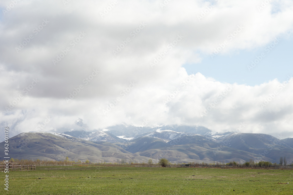 Beautiful mountain landscape. Wildlife Kyrgyzstan. Clouds in the sky. Kyrgyzstan