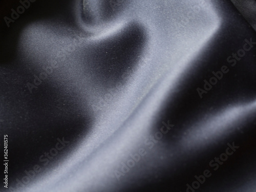 Smooth elegant grey silver silk or satin texture can use as background. silver fabric texture close up