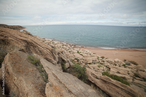 Beautiful mountain landscape. The shore of Lake Issyk-Kul. Wildlife of Kyrgyzstan. Clouds in the sky.