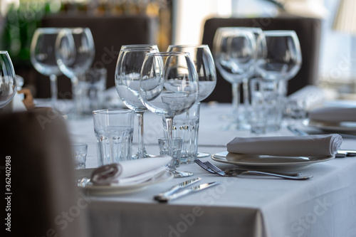 Empty glasses in restaurant background. Table set for an event party or wedding reception.