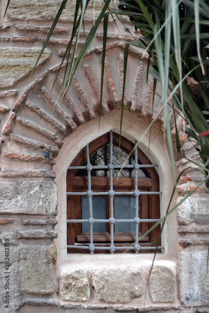 Historical old stone wall structure and window on it.