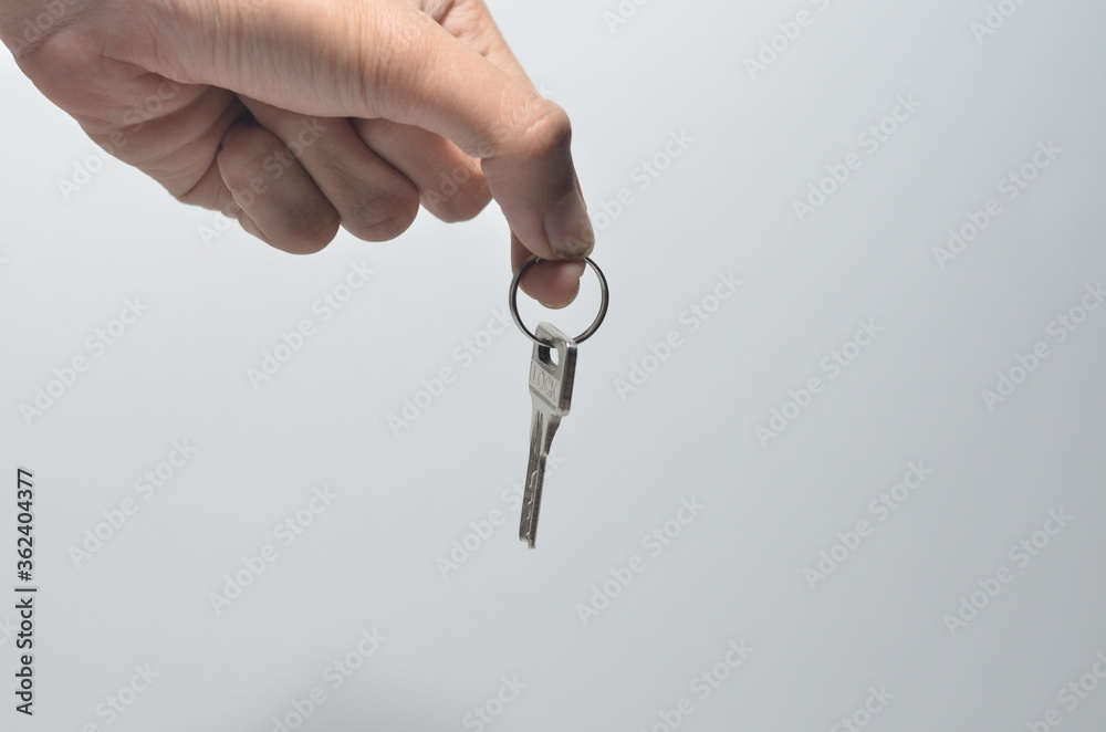 Hand Giving a Key With Isolated White Background Hand Giving a Key With Isolated White Background