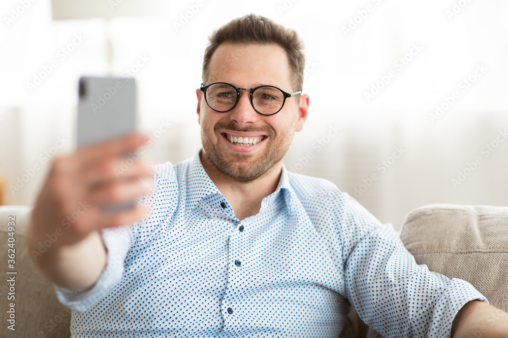 Happy man using smart phone for video call or selfie