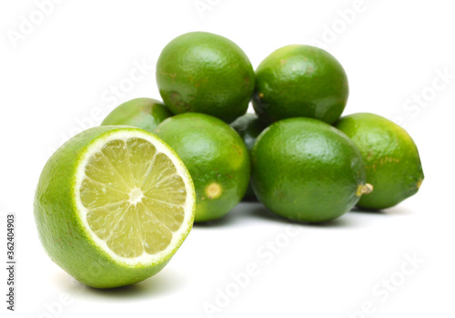 Stack green Lemons on white background