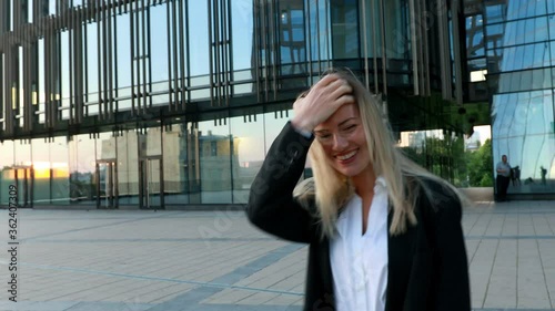 Funny business woman in suit making fun playing with her hair Beautiful blonde tossing her hair