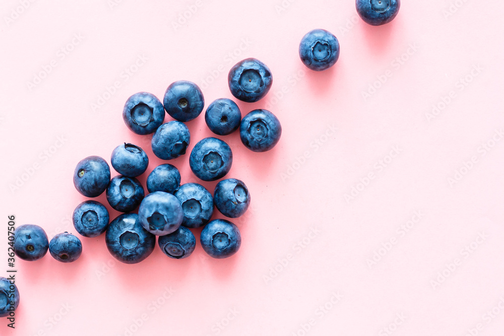 Colorful fruit pattern of blueberries on pink background. Top view. Flat lay Colorful fruit pattern of blueberries on pink background. Top view. Flat lay