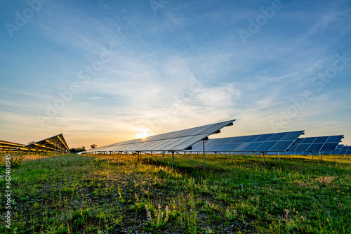 Bild auf Leinwand ground mounted photovoltaic power station at sunset