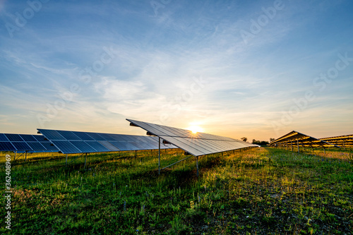 ground mounted photovoltaic power station at sunset photo