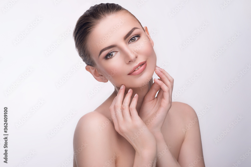 Beauty portrait of beautiful young woman with clean skin touching her neck with hands. Wellness, skincare, spa Beauty portrait of beautiful young woman with clean skin touching her neck with hands. Wellness, skincare, spa