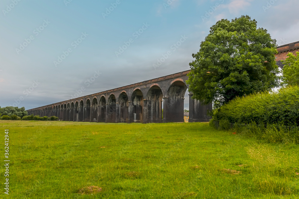 Obraz premium A view towards the western end of the Harringworth railway viaduct, the longest masonry viaduct in the UK