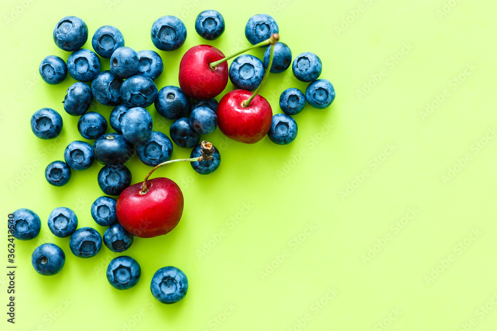 Many fresh blueberries on green-yellow background Many fresh blueberries on green-yellow background