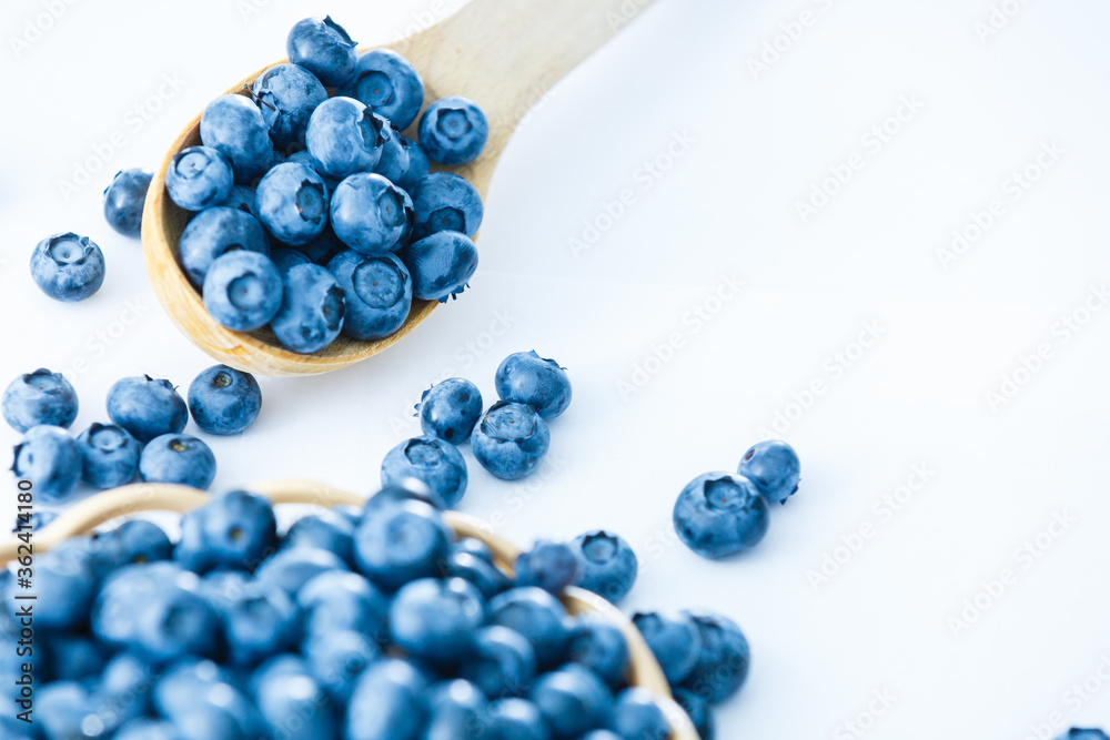 blueberries in bamboo basket on white background blueberries in bamboo basket on white background