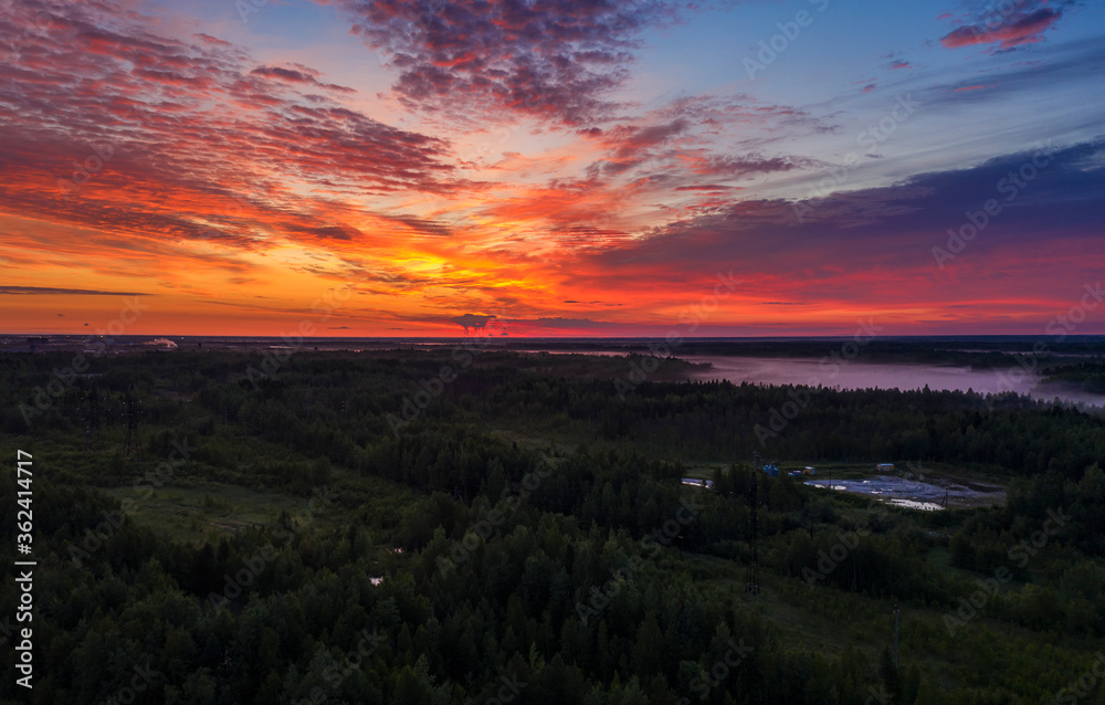 panorama of dawn in the Northern region of Russia, Khanty-Mansiysk, white nights with stunning orange dawn and clouds